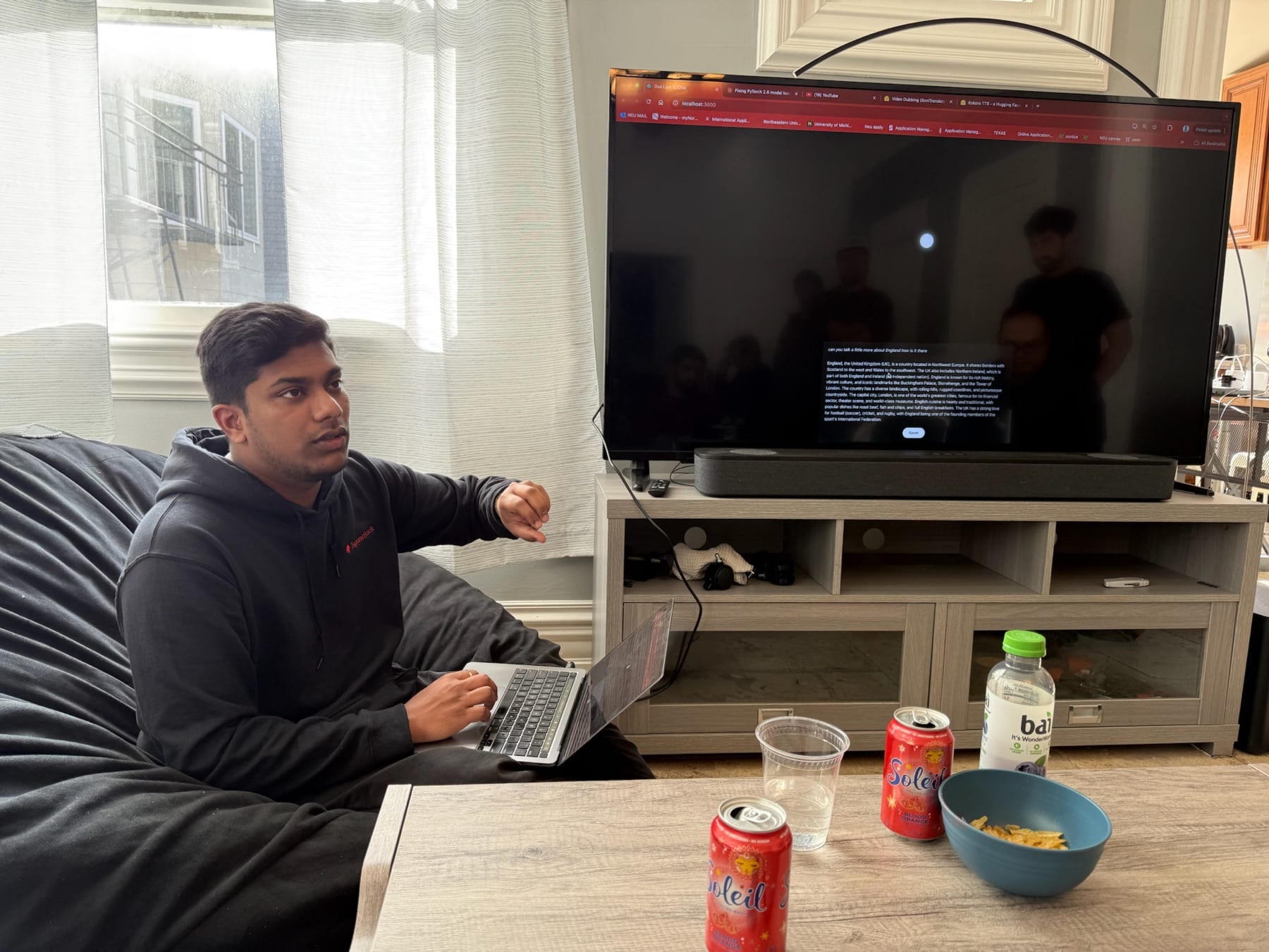 A housemate presenting a project on the living room screen